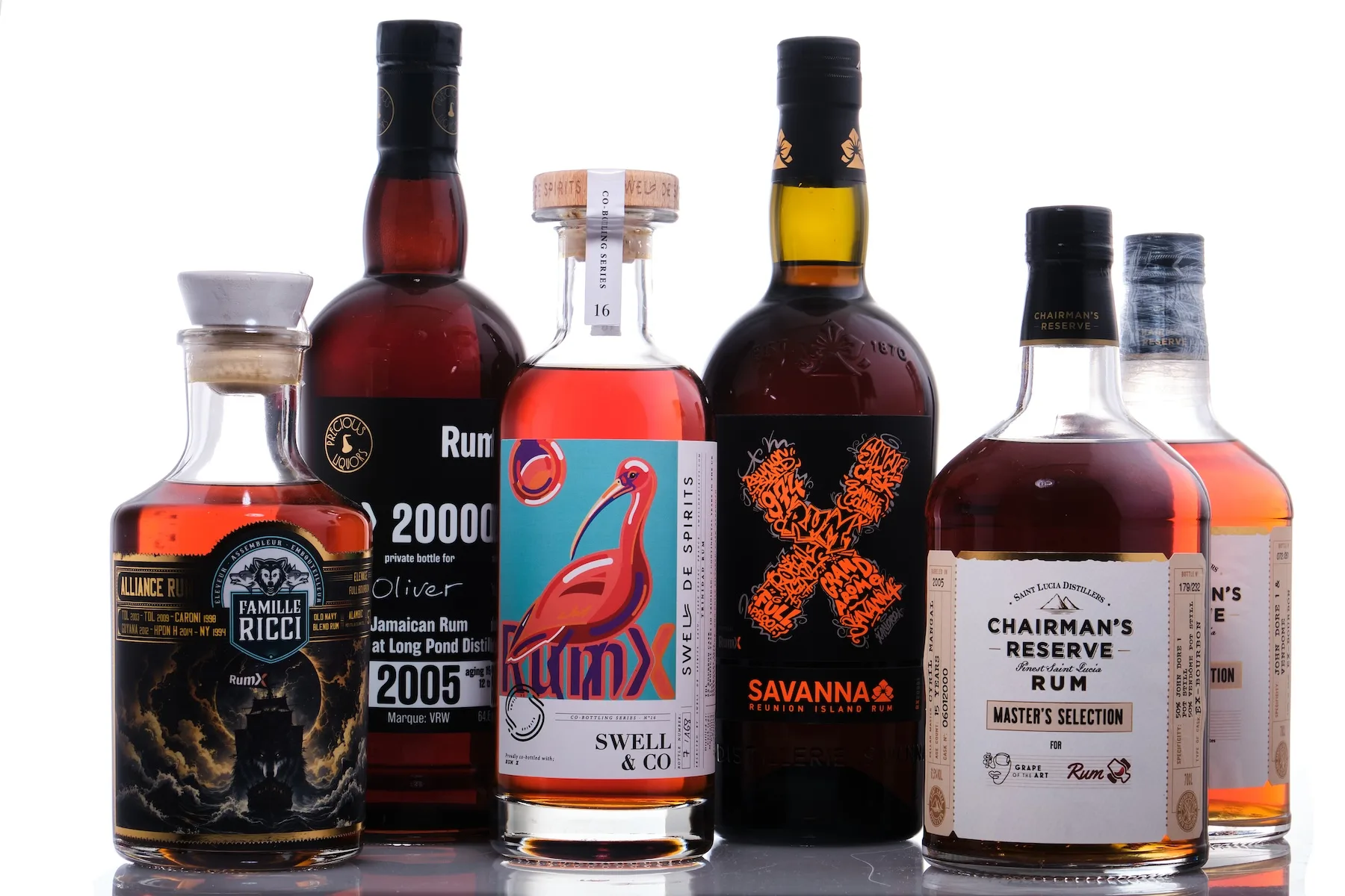 The six RumX co-bottlings side by side: Famille Ricci Navy Blend, Long Pond 2005 VRW, Swell & Co T.D.L 2001, Savanna Grand Arôme 2007 and two Chairman's Reserve Master's Selection