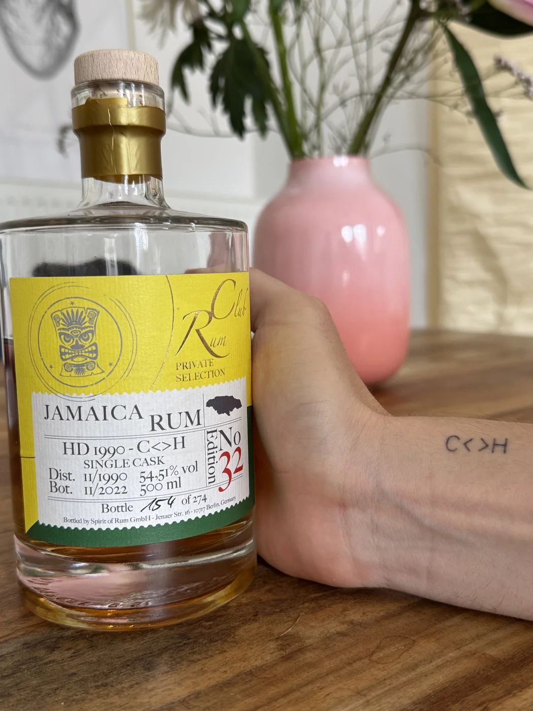 C<>H tattoo on the wrist, next to a bottle of Hampden HD 1990 C<>H Single Cask Edition No 32